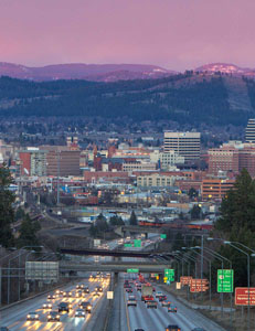 Dusk freeway approaching downtown with purple mountains