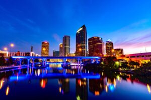 Downtown towers reflected in illuminated river