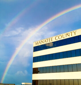 Double rainbow above Manatee County building image.