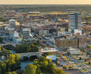 Aerial cityscape with river, bridges, and green parks