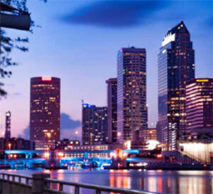 Nighttime city skyline reflecting on riverfront