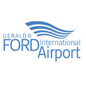Blue text airport logo with wave motif