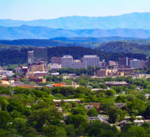 City skyline with layered blue mountain ridges