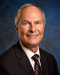 Smiling older man in dark suit
