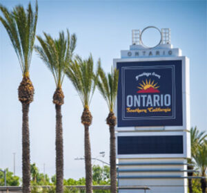 Ontario welcome sign framed by palm trees