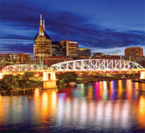 Illuminated bridge and skyline reflected in water
