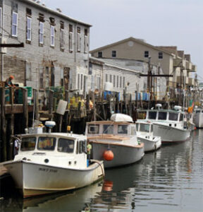 Fishing boats moored along a wooden waterfront