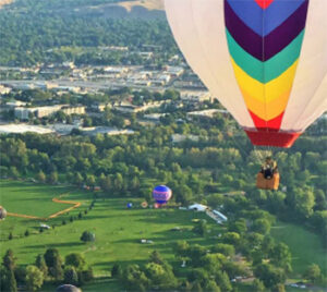 Colorful hot air balloon over green park