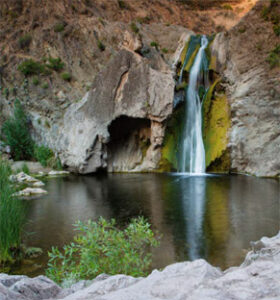 Waterfall cascading into a rocky pool
