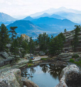 Mountain basin with reflective pool and distant peaks