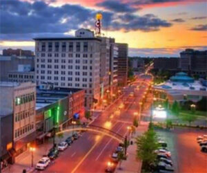Downtown street lit by sunset city lights