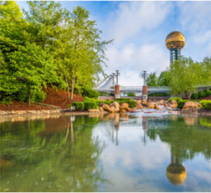 Gold globe tower reflected in park pond
