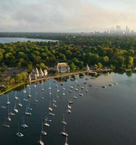Aerial marina with anchored sailboats and shoreline