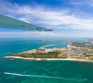 Aerial view of turquoise coastline from airplane