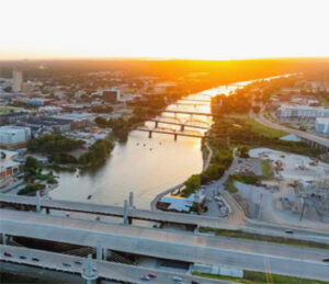 Sunrise over river with multiple bridges