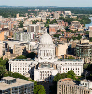 White capitol dome surrounded by city