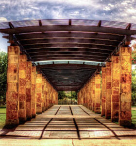 Stone column pergola casting geometric shadows