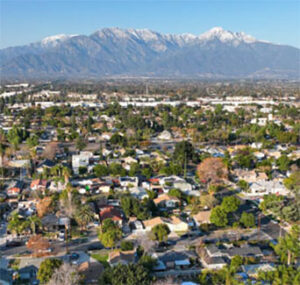 Aerial view of suburb with mountain backdrop