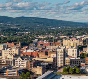 Aerial view of mid-sized city by green hills