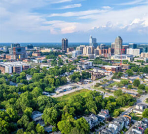 Aerial view of city skyline and tree-lined neighborhoods