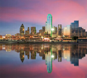 City skyline reflected on calm water at dusk