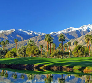 Palm-lined golf course with snow-capped mountains