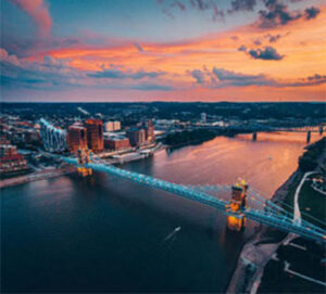 Aerial view of lit suspension bridge at dusk