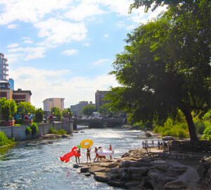 Families playing with inflatables on riverbank
