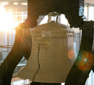 Large Lego-style Liberty Bell sculpture indoors