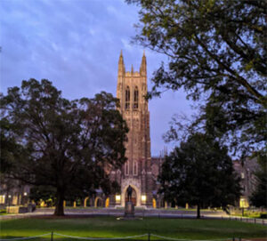 Gothic chapel tower at dusk on campus